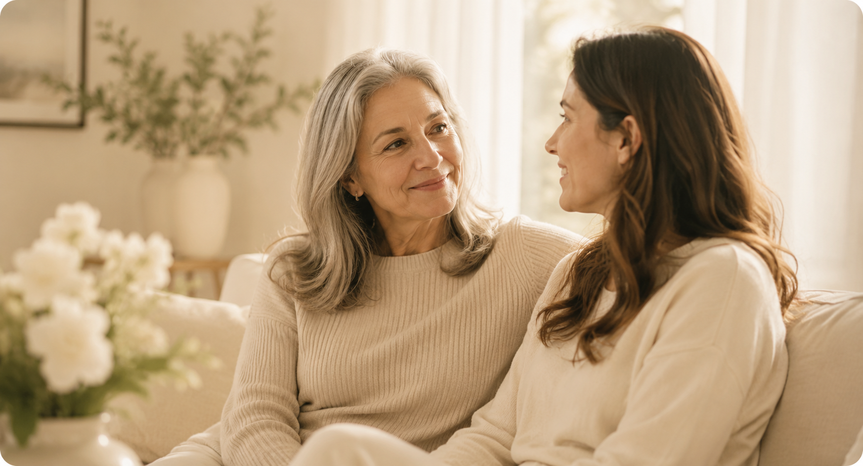 Two women in warm conversation on a sofa